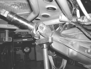 Supporting the rear differential remove and discard the rear shocks, save the hardware. Use care not to over extend the brake hoses. 3.