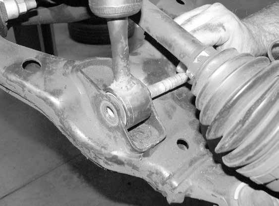 dislodge the ball joints. Use care not to hit the ball joints when removing. 3. Remove the upper control arm and retain the factory hardware.