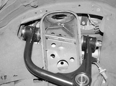 Insert the uniball pin into the factory knuckle upper ball joint taper. Install the 9/16-18 lock nut with thread lock compound and flat washer onto the bottom side of the pin.