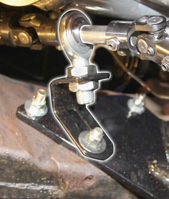 On the passenger side, use the bottom idler arm bolt and hole just to the rear of the idler arm and