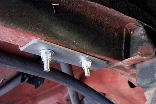 3. The square U-bolts hold the upper cradle in place and will slide through two existing holes. Some cars may not have these holes.