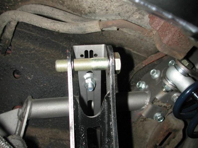 Using another 5/8 x 2 ¾ bolt, fasten the axle tabs to the other end. The tabs must be bolted to the outside of the jig. Swing the bar down letting the tabs rest onto the axle.