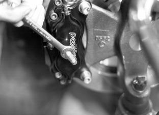Use a 3/8 wrench to tighten the brake line adapter fitting.