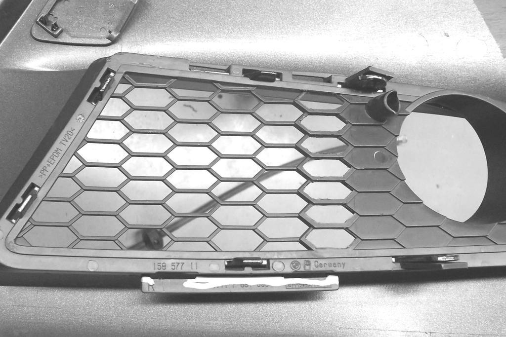 46. Cut out the material in the passenger side grill as shown. Use a sharp X-Acto knife to carefully cut the center out of each opening area like the existing openings. See figure 50.
