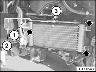 13. Remove the three screws marked with arrows that hold the duct to the oil cooler (3).