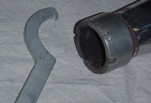 Loosen the compression joint (muffler nut) at the front of the mufflers with the