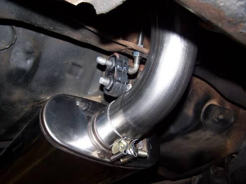 Select the two threaded muffler hangers and install one of the flanged nuts on each of the hangers. Be sure to install the flange is facing away from the angled portion of the hanger.