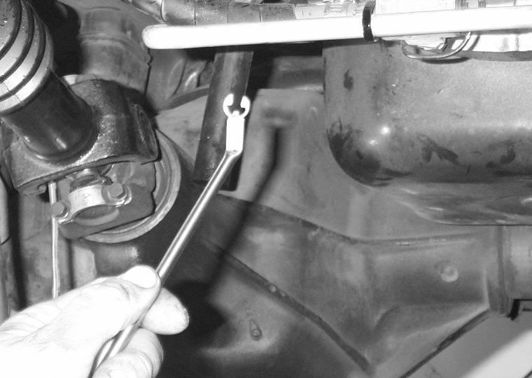Once the valve body is in position, insert the park rod into the manual shift lever and hold the valve body in place with a couple of bolts. 23.