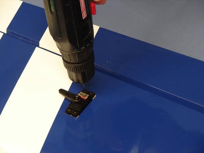 Install servo in servo well with the output arm toward the leading edge of the wing.