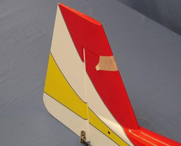 23. Tape the rudder balance tab to the top leading edge of the vertical fin in the neutral position as shown.