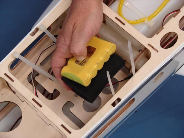 Secure the receiver battery to the fuse floor using the