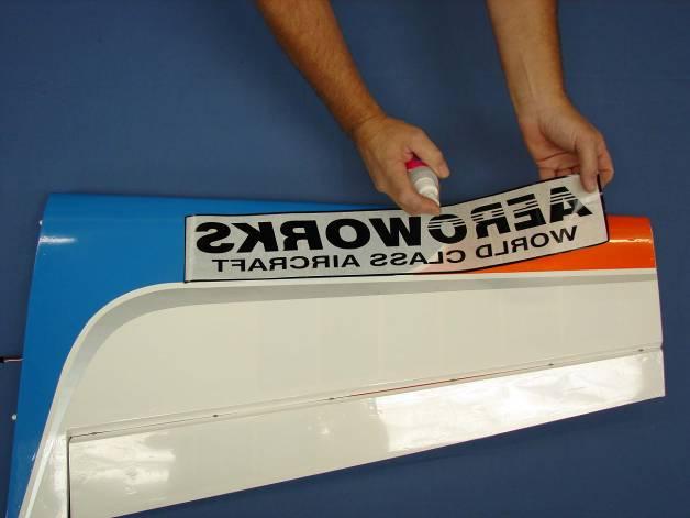 8. Spray back side of decal with application fluid, Windex or soapy water solution. 10. Using a plastic squeegee or credit card.