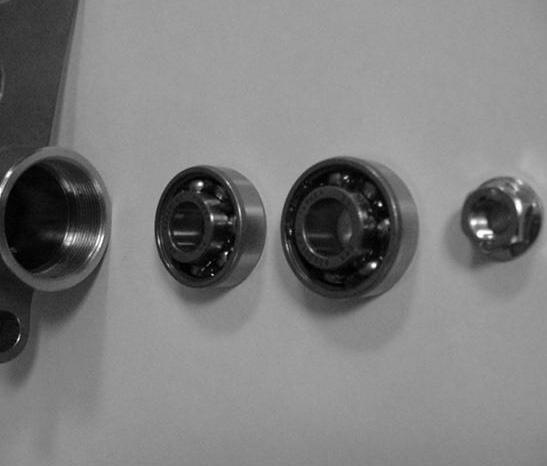 8. Insert the bearings onto the groomer shaft in groomer housing (Fig. 7). The extended bearing races should contact each other when installed to create a /4 gap between the bearings.