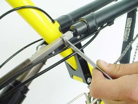 Use the supplied short-end Allen Wrench to hold the bolt while spinning the drive system by hand to remove the