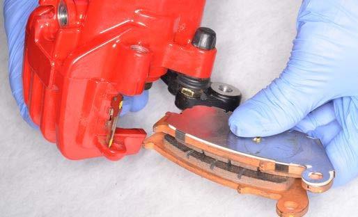 Install the brake pad spring into the
