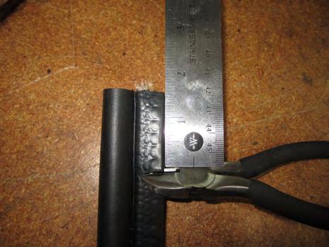 e. Cut slits in the edge trim seal (J) on one side of the clamp using a razor or wire cutters