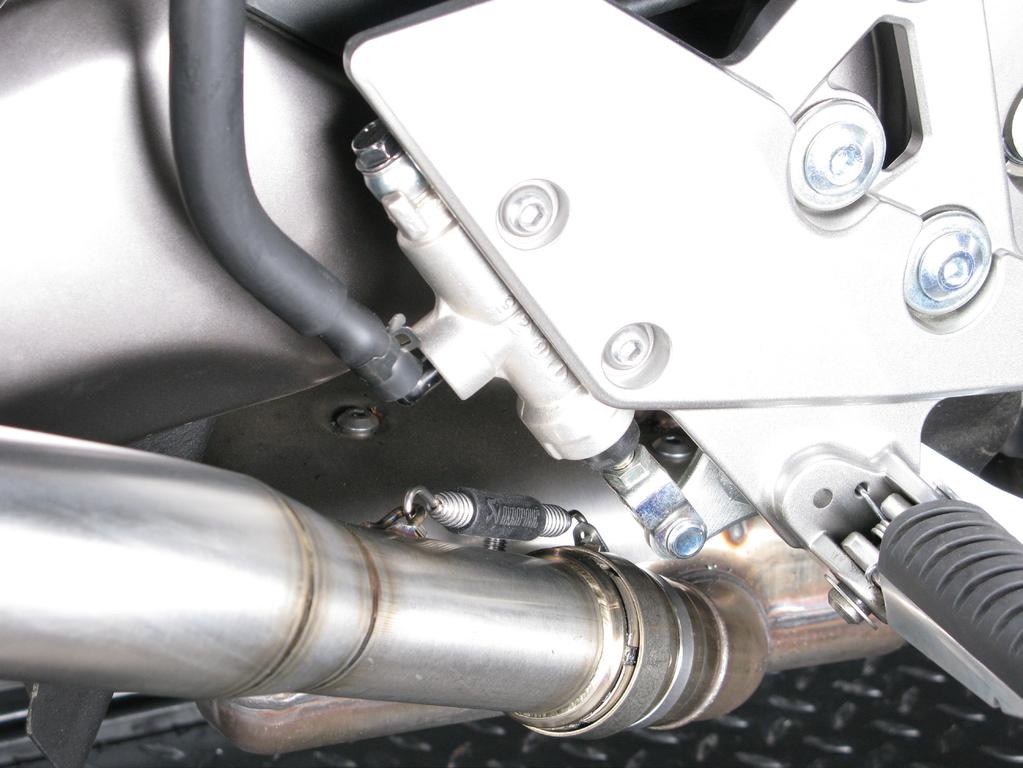 Align the muffler in respect to the motorcycle and tighten the carbon