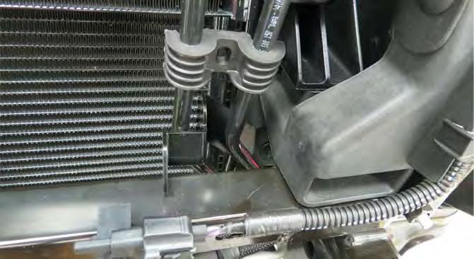 93. Loosely secure the lower driver LTR bracket to the lower driver side condenser