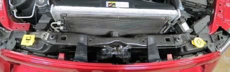 16. Using a 10mm socket, remove four (4) bolts securing the grill.