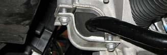 Place a catch pan below the steering gear then use an 18mm line wrench to