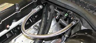 Slide the crossover hose under the snout and air inlet of the supercharger as you install the passenger side