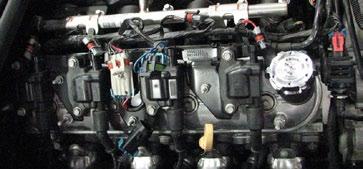 Remove coil covers from valve covers by lifting up and working fuel line through slot on driver side.