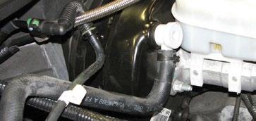 of the manifold next to the larger brake booster hose, if it is present.