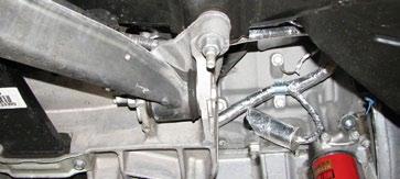Use the pry bar to widen the gap when needed and push the brake lines out of the way to clear the gearbox.