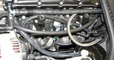 NOTE: It is necessary to drain the engine coolant and remove the upper radiator hose to install the serpentine belt.