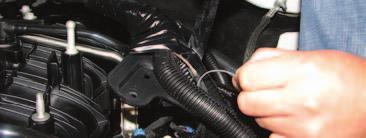 9. Remove the top engine harness retainer bracket by removing the three