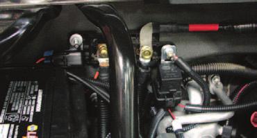 NOTE: Proceed with Step 115 if your vehicle is equipped with a firewall mounted power junction. Otherwise, disregard and proceed to Step 116. 115. Using a 10mm socket, secure the fuse holder on the Water Pump harness to the left mounting stud of the power junction as shown below.