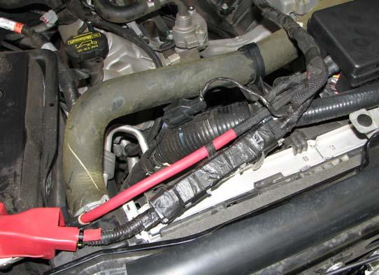 24. Support the alternator while using a 10mm socket to loosen the two bolts that support the alternator.