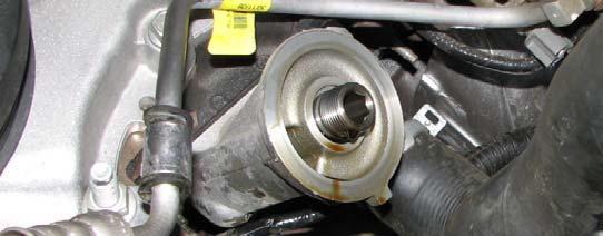It is not necessary to fully drain the oil pan. 60. Use a 10mm socket to unbolt and remove the oil splash shield. 55.