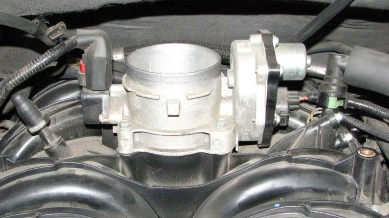 24. Use a 10mm socket to remove the four bolts that secure the throttle body. 27.