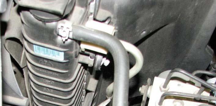 Use a panel puller to separate the wire harness from the alternator strap. 31.