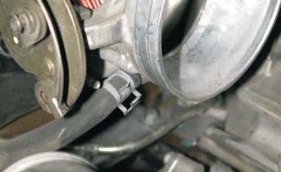 17. Using a long pair of pliers, remove the coolant hoses from the