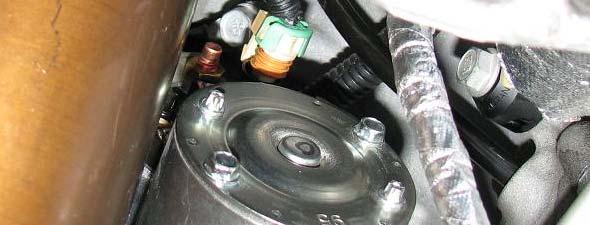 Use a 13mm socket to remove the nuts retaining power wires to the starter. 55.
