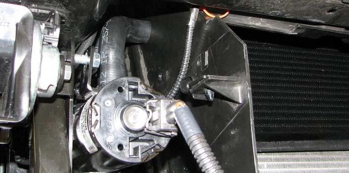 Route the intercooler water pump wire harness extending from the relay down to the