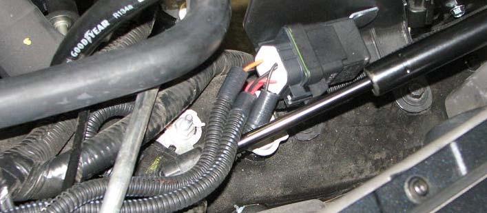Install long end of molded hose on intercooler reservoir outlet so that the hose will extend out and then turn