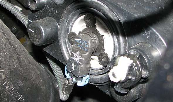 9. Disconnect the indicator and fog lamp electrical connectors. 13.