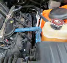 Use a 3/8 drive breaker bar to loosen the tension on the belt tensioner and remove the