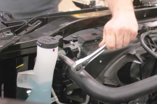 41. Use a 10mm wrench to remove the four headlight mounting bolts on the right side of the vehicle.