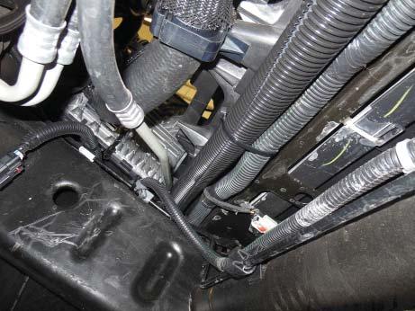 Run the opposite end of the Pump to Lower LTR hose behind the lower portion of the radiator as shown and