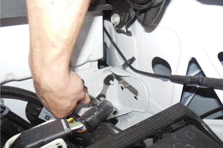 To install your intercooler pump harness bracket, begin by