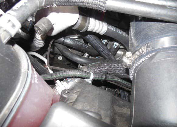 Use a tie wrap to secure the harness to the factory heater hose as shown by the red arrow to the left. 151.