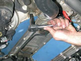 Using a 10mm socket wrench, remove the two or four coolant vent pipe