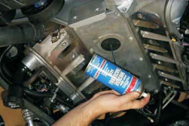 Remove the long oil filler neck from the valve cover by rotating it 180 degrees counter