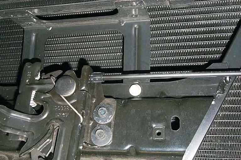 147. Remove the bolt located below and to the right of the hood