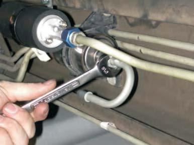 While supporting the pump using back-up 7/8 wrench, tighten