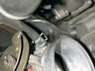 Using a long pair of pliers, remove the coolant hoses from the